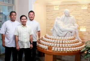 Rev. Fr. Raymond Vincent Ma. Decipeda (far right), Rev. Fr. Joachim Eugene Ma. Ablanida (center), Rev. Fr. Pius Noel Ma. Pareja (far left) adore their replica of ‘The Pieta’ located in the vestibule at Holy Family Catholic Church Artesia. Daniel E. Beckham Photo.