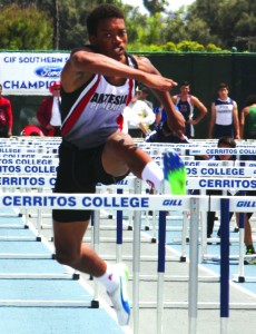 Artesia senior Jaydon Logan heads for the stretch run in the 110 meter high hurdles in last Saturday's California Interscholastic Federation-Southern Section Track and Field Divisional Finals. Logan finished in fifth place in Division III with a time of 14.81. PHOTO BY ARMANDO VARGAS