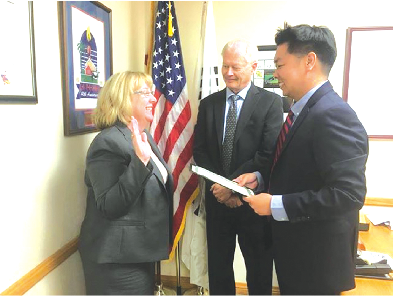 La Palma Mayor Peter Kim administers the oath of office to newly appointed City Manager Laurie T. Murray. Witnessing the occasion is La Palma City Councilman Gerard Goedhart.