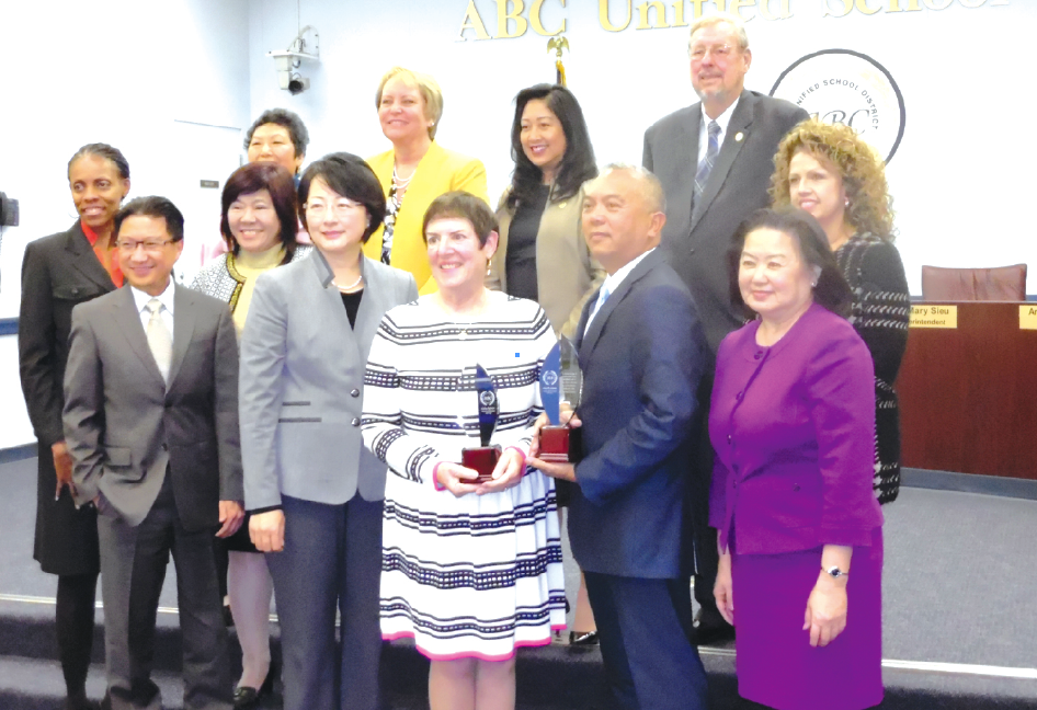 ABCUSD Board, Superintendent and staff stand with Armin Reyes and Celia Spitzer at this past Tuesday's meeting. Photo by Tammye McDuff.