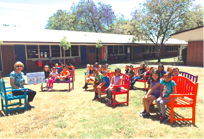 A Dulles Elementary School classroom takes its reading outside to a brand new outdoor reading space. Dulles Elementary and Love La Mirada partnered to build eight benches, a chair and table, and planted three trees to create the reading space.
