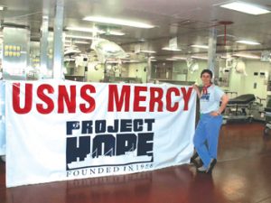 Carole Snyder, a US Army veteran, a RN, and PIH Health's Program Manager of Emergency Preparedness, onboard the USNS Mercy. Snyder travelled on the Mercy to Sumatra after the earthquake, helping-injured patients, and providing humanitarian care.