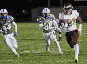 Valley Christian High junior running back Gianni Hurd looks to escape El Rancho High's Jordan Jimenez (#44) and Andrew Ortiz in last Friday night's California Interscholastic Federation-Southern Section Division 9 quarterfinal game. Hurd ran for 99 yards on 17 carries and scored once in V.C.'s 37-12 victory. PHOTO BY ARMANDO VARGAS, Contributing photographer