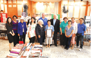 Front row, left to right: City Librarian and Marketing Manager Annie Hylton, Librarian II Padmini Prabhakar, Friends of the Cerritos Library members Jackie Henry, Bernice McCants and Marie Garcia, Friends President Janice Dawson and Friends member Candy Yee Second row, left to right: Friends members Terry Versluys and John Dawson, Mayor George Ray, Friends Vice President/Programs Tracy Winkler and Friends members Kit Snider and Donald Chen. Photo courtesy City  of Cerritos. 