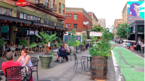 Diners from two restaurants in Portland, Oregon, Zeus Cafe and Jake's, enjoy the newly reclaimed street space next to a "bicycle boulevard"
